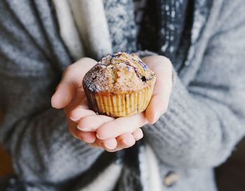 Close-up of hand holding ice cream