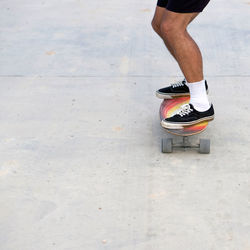 Low section of man skating outdoors