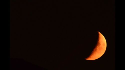 Low angle view of moon against sky at night