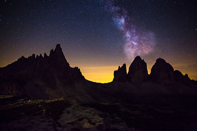 Scenic view of mountains against sky at night