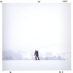 People standing on snow covered field