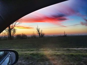 Car on road against sky during sunset