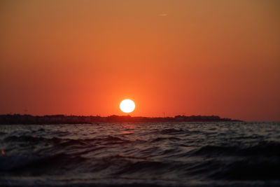 Scenic view of sea against romantic sky at sunset