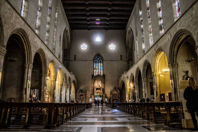 People in illuminated cathedral