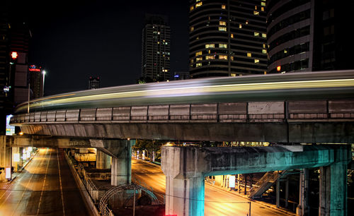 Blurred motion of train on bridge at night