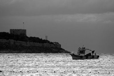Sailboat sailing on sea against sky