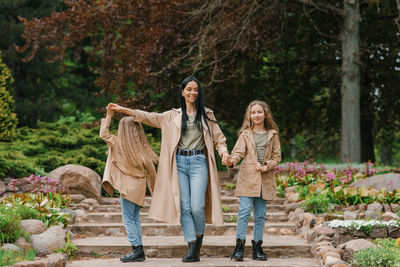 Caucasian stylish family in the same clothes have fun in the spring in the park