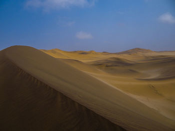 Photograph of a sand dune in the namib desert near swakopmund, namibia on a sunny dry season morning