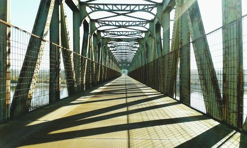 Metallic footbridge with shadow