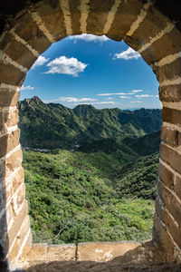 Scenic view of mountains against cloudy sky