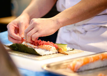 Midsection of man preparing food