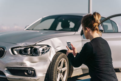 Rear view of man using mobile phone