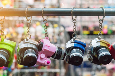 Close-up of camera key rings hanging for sale at market stall
