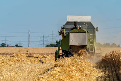 Vehicle of field against sky