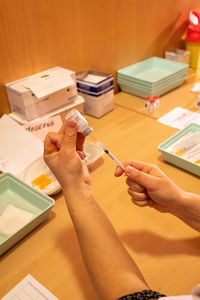 Cropped hands of doctor examining patient in clinic