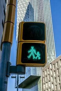 Low angle view of road signal against buildings