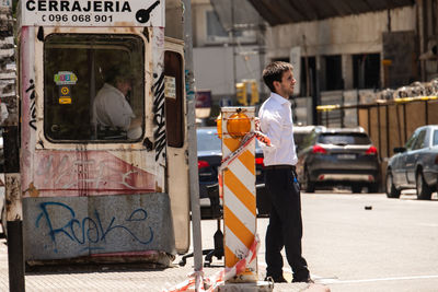 Man standing on street in city