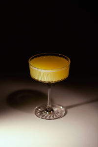 Glass of orange alcohol free mimosa cocktail. refreshing mocktail on dark background