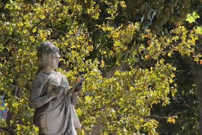 Statue against trees and plants
