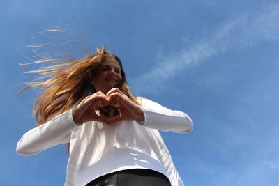 Low angle view of woman against sky