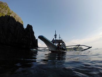 Boat moored in sea against sky