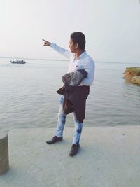 Side view of young man standing on beach