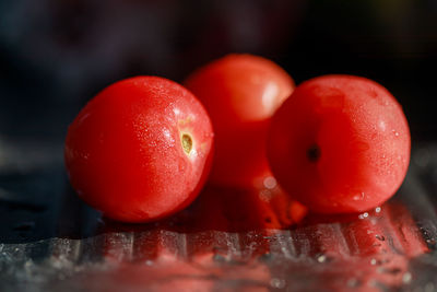 Close-up of wet tomatoes on table