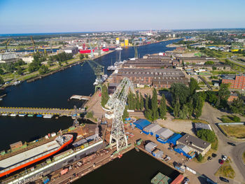 High angle view of cityscape by sea against sky