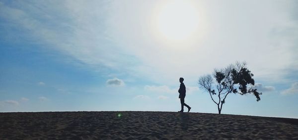 Man standing on land against sky