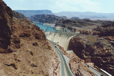 Panoramic view of dam and mountains against sky