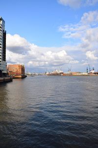 Scenic view of sea by city against sky