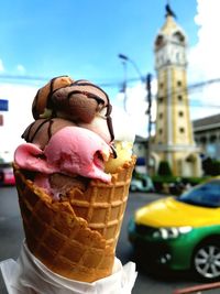Close-up of ice cream cone against buildings
