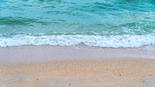 High angle view of waves rushing towards shore