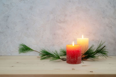 Close-up of illuminated candles on table