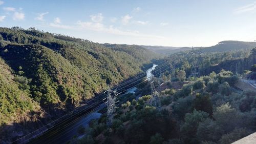 High angle view of road amidst trees against sky