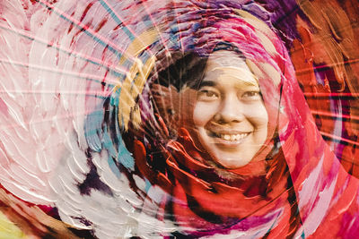 Digital composite image of smiling young woman wearing hijab