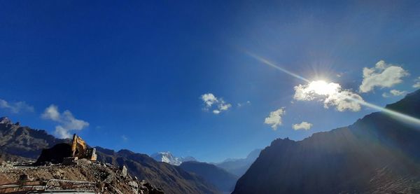 Low angle view of mountains against blue sky