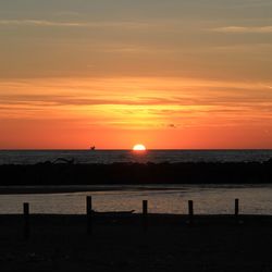 Scenic view of sea against orange sky