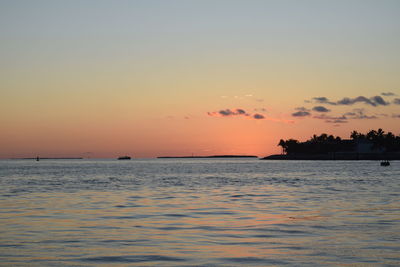 Scenic view of sea against romantic sky at sunset