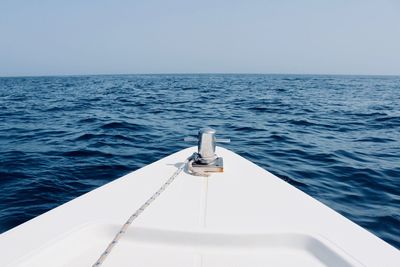 Sailboat sailing in sea against clear sky