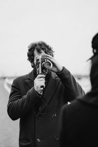 Young man photographing