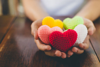 Close-up of woman holding heart shape