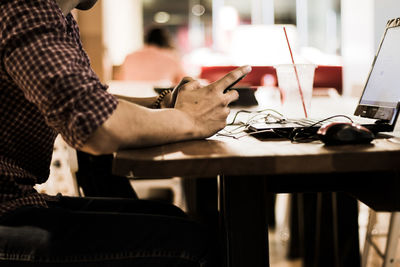 Side view of a man sitting at table