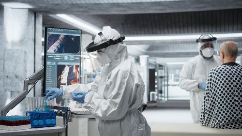 Rear view of scientist working in laboratory