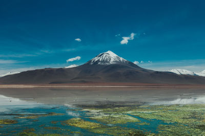 Scenic view of mountain against blue sky