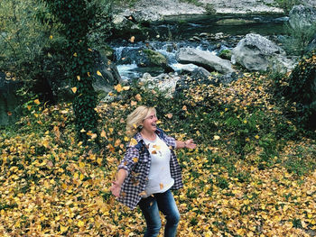 Woman standing by plants