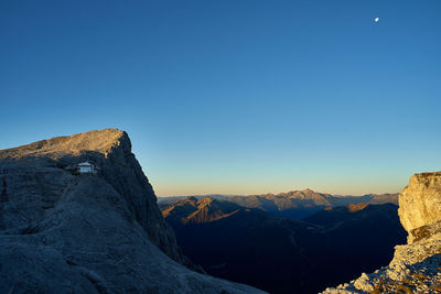 Scenic view of mountains against clear blue sky