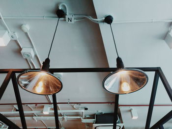 Low angle view of illuminated pendant lights