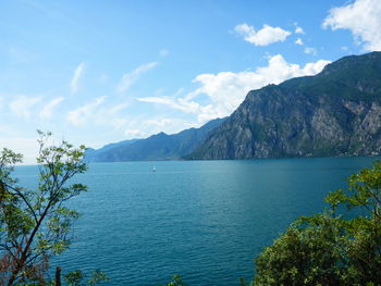 Scenic view of sea and mountains against sky