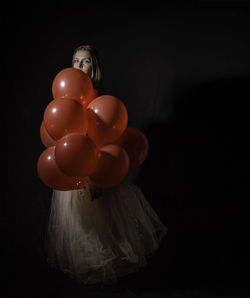 Close-up of multi colored balloons against black background